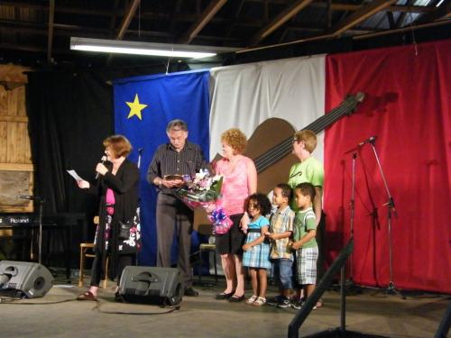 Jamboree - Peter Chaisson receiving Golden Fiddle Award with Doreen, Melanie's kids, Caroline A., & Colette Aucoin on mic